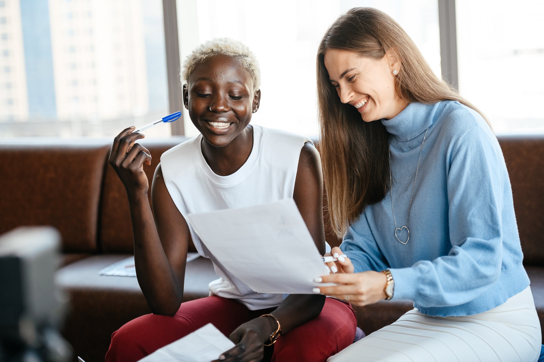 cheerful multiethnic colleagues discussing contract in office